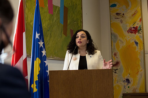 Kosovo’s President, H.E. Dr. Vjosa Osmani talking at a podium