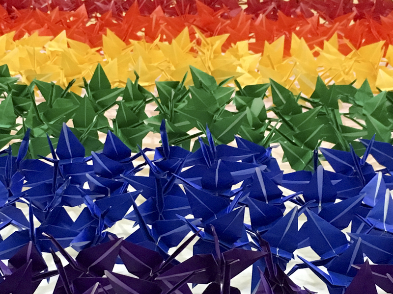 A rainbow of pride origami cranes.