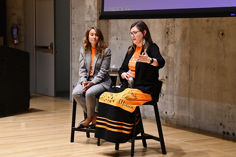Kisha Supernant talking to another person on stage