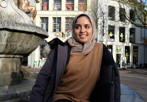 Rowaida Hussein in front of a fountain in Amsterdam