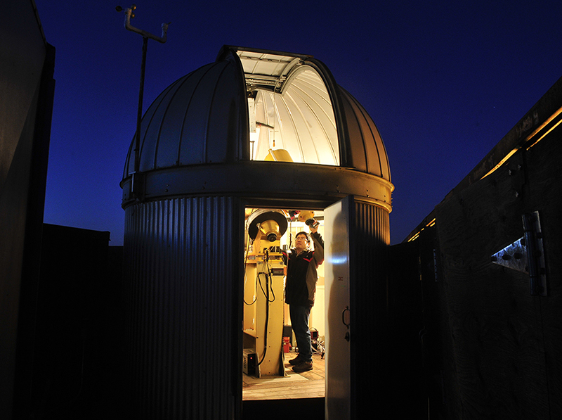 An exterior view of a telescope at night.