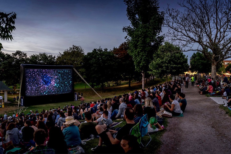 Thousands of people in a Toronto park watching a movie