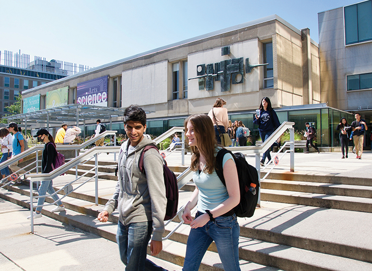 Sid Smith Hall exterior and students walking around on a sunny day.