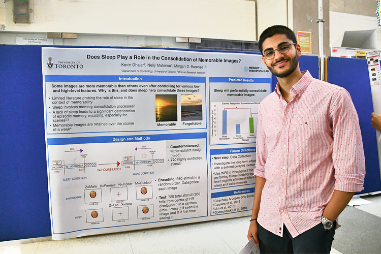 Kevin Ghajar standing in front of his poster