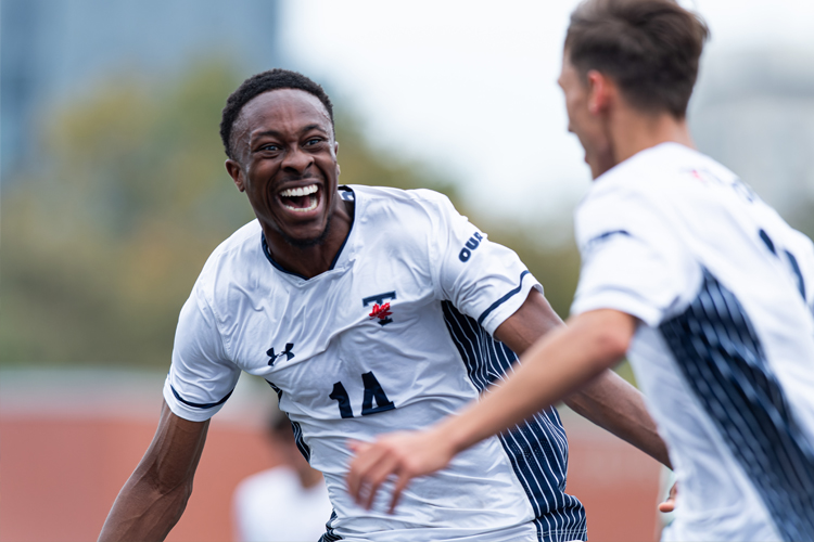Kingsley Belele smiling while playing on the field.