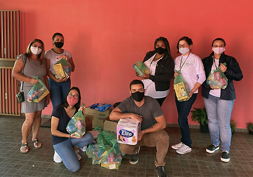 Soap for All team poses with packages.