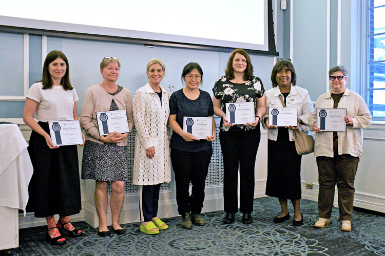 A group of people standing with certificates. Left to right: Meghan Sbrocchi, Angela Hansen, Dean Melanie Woodin, Lilian Leung, Tamara Ferguson, Jemima Meriscam and Christine Elias.