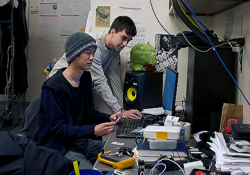 Two PhD students working at a computer