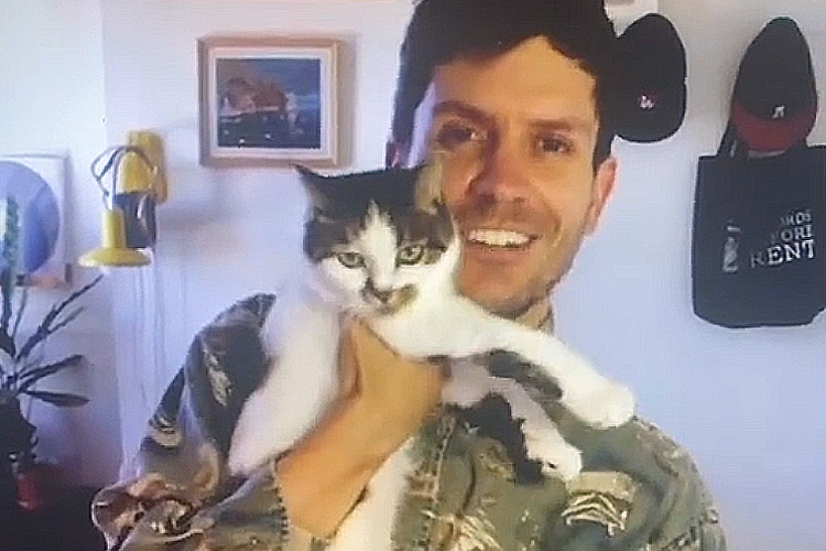 Adam Hammond holds his cat Wendy.