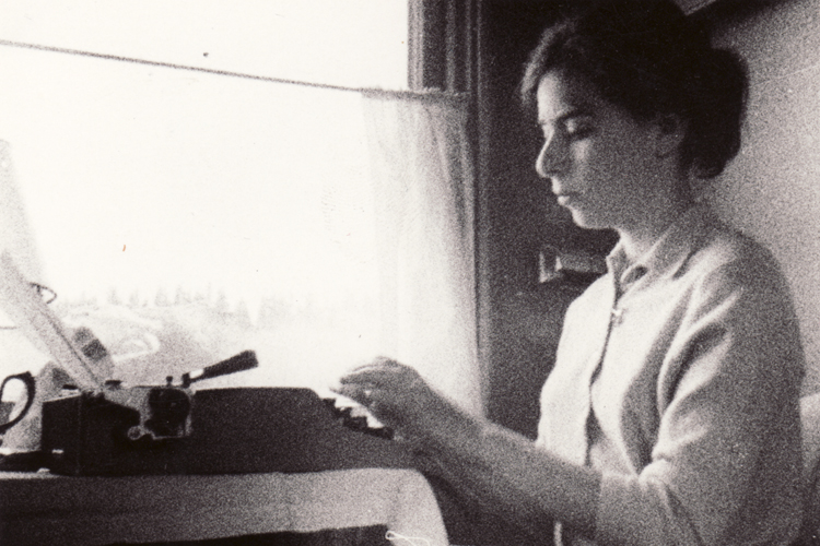 Linda Munk writes on her portable Olivetti typewriter.