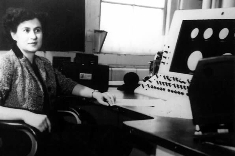 Beatrice “Trixie” Worsley poses in front of Canada's first electronic computer.