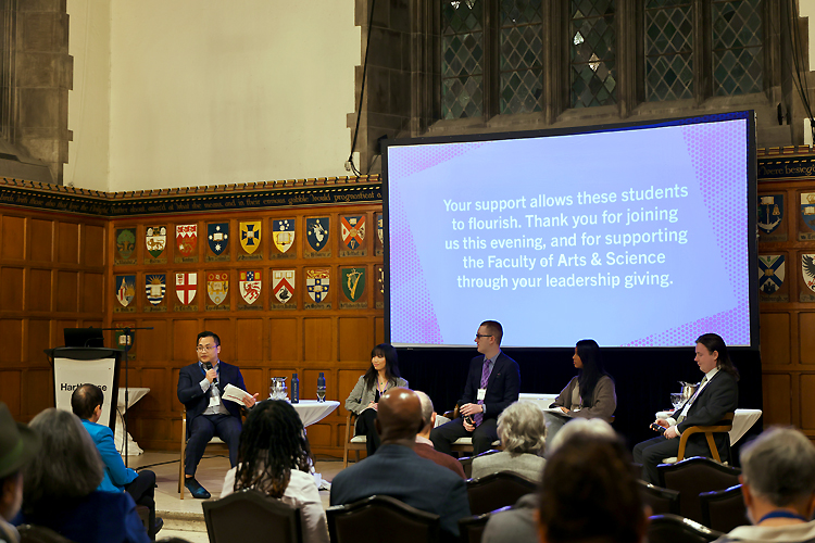 A large group of people listen to alum Eugene Choi and a panel of current students.