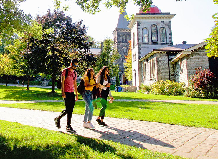 Three students walking outside.