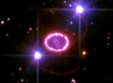 This Hubble Space Telescope image of the remnant of Supernova 1987A shows a bright inner ring glowing as it interacts with material from the supernova blast.
