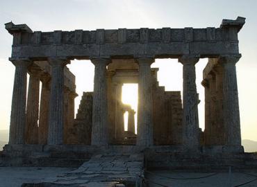 Temple of Athena Aphaia with sun behind it, Aegina Island, Greece 