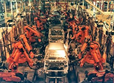 Robots building cars in a car factory