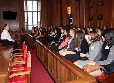 Young women listening to a presenter in the House of Commons