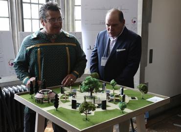 Chief Stacey Laforme and James Bird looking over the model for a “reconciliation grove” 