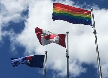 The U of T, Canadian and Pride flags 