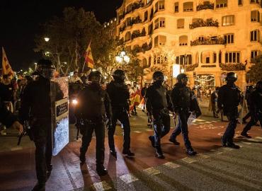 Catalan riot police officers control demonstrators in Barcelona, Spain