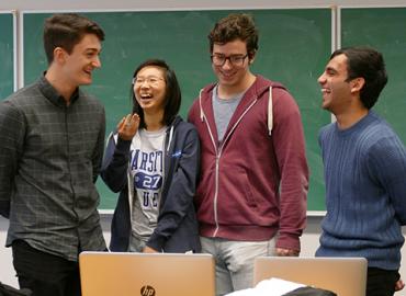 Four of the team members receive the call from the Bank of Canada informing them of their place in the final.