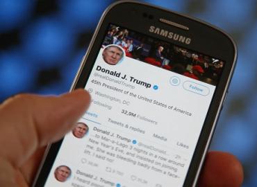 Donald J. Trump&amp;#039;s multiple tweets on his twitter account on a cell phone.