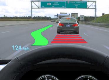 Example of an augmented reality head-up display, including red lines and a green arrow