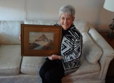 Diana Parks McIntyre with painting of the Canadian Rockies