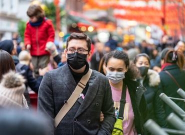 people in medical masks on street