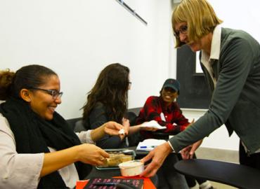 Lori Stahlbard serving food to a student