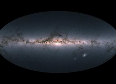 A circle with a bright light in a horizontal line known as the milky way.