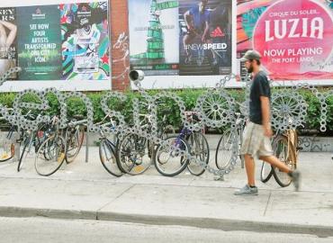 Bicycle rack made of bicycle parts spells out the word Kensington.