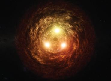 A large orange spiral with three large bright lights around a black hole showing the mid-infrared (IR) flare from the supermassive black hole (SMBH).