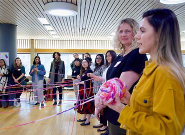 Student holds yarn during group reflection activity.