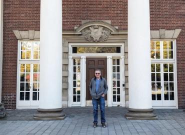 David Dyzenhaus standing in front of a building.