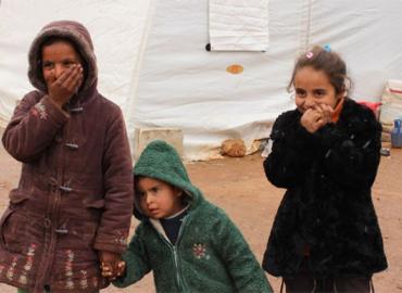 Three children in a refugee camp in Aleppo