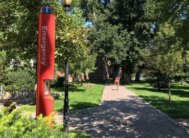 Emergency call station near walking paths on campus.