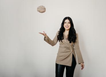Dr. Samantha Yammine holding a model of a brain