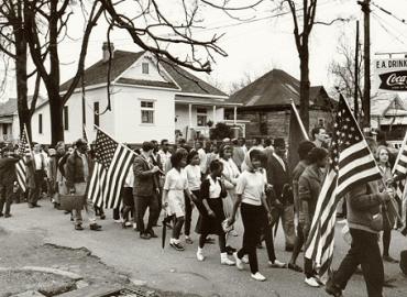 A group of Americans marching with American flags