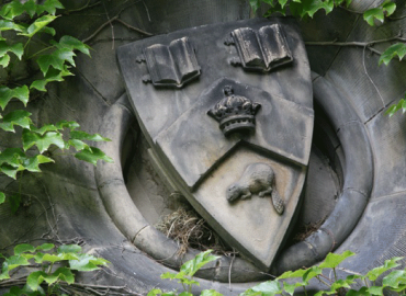 St. George campus, close-up of crest on an exterior wall. 