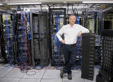 Geoffrey Hinton stands in a computer server room