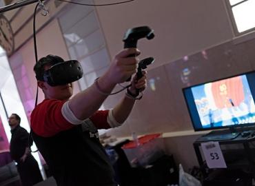 Student playing a VR game at the event
