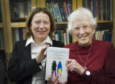 Alana Johns and Jean Briggs holding their book.