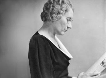 Federal Member of Parliament, Agnes Macphail reading a newspaper in profile