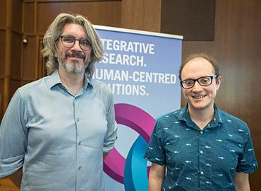 SRI Faculty Fellow William Cunningham and Joel Leibo standing toegther