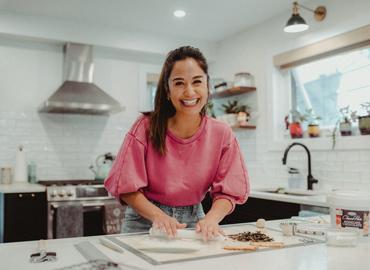 April Julian rolling dough.