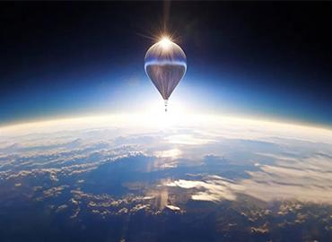 A balloon high in the sky above the earth