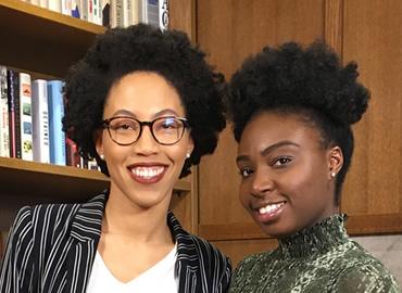 Anna-Kay Russell and Eunice Kays standing in front of a bookshelf.