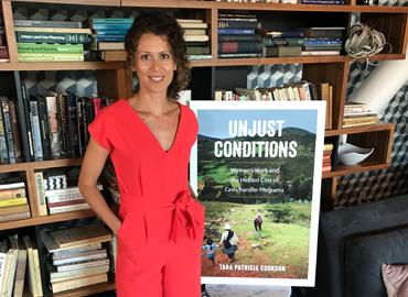 Tara Patricia Cookson in front of a bookshelf