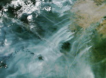 A satellite image showing smoke across land and sky.
